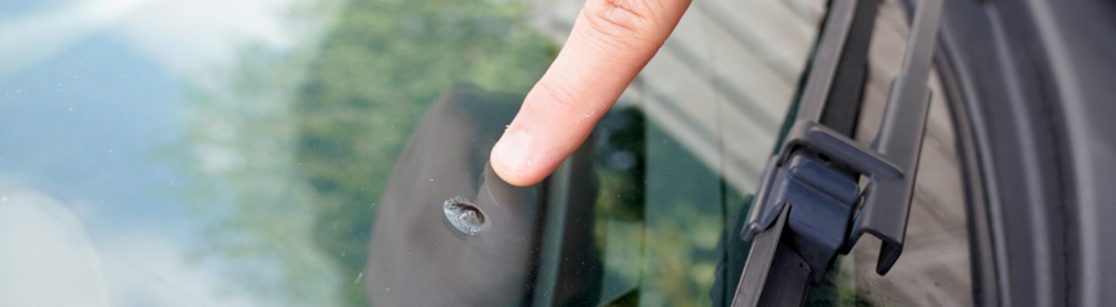 man-see-car-accident-stone-damage-broken-windshield-while-driving.jpg